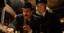 Actor Sam Rockwell crouches down to inspect something we can't see. Beside him is actress Saoirse Ronan. Both are dressed in 1950s clothing, and are in some sort of police uniform