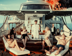 A group of rich people lounge on a luxury yacht that has caught fire